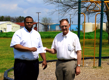 Two men at check presentation outside