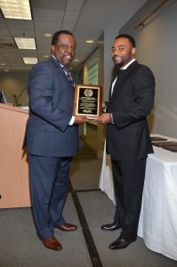 Myron Jackson, President and CEO of the Design Group, presents Southern Bancorp CEO, Darrin Williams, with the Supporting Organization of the Year Award